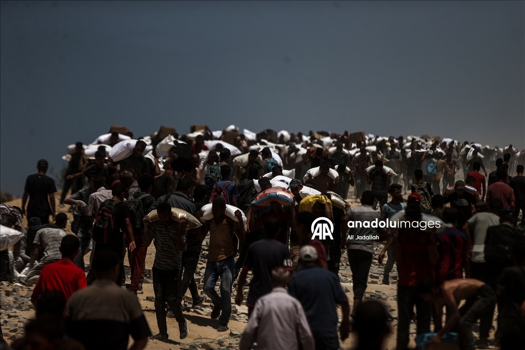 Palestinians receive limited amount of flour and infant formula at distribution point in Gaza