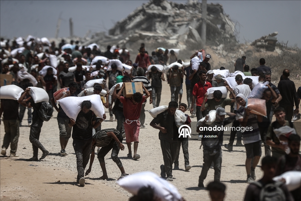Palestinians receive limited amount of flour and infant formula at distribution point in Gaza