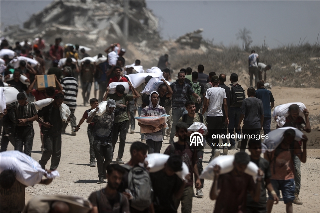 Palestinians receive limited amount of flour and infant formula at distribution point in Gaza