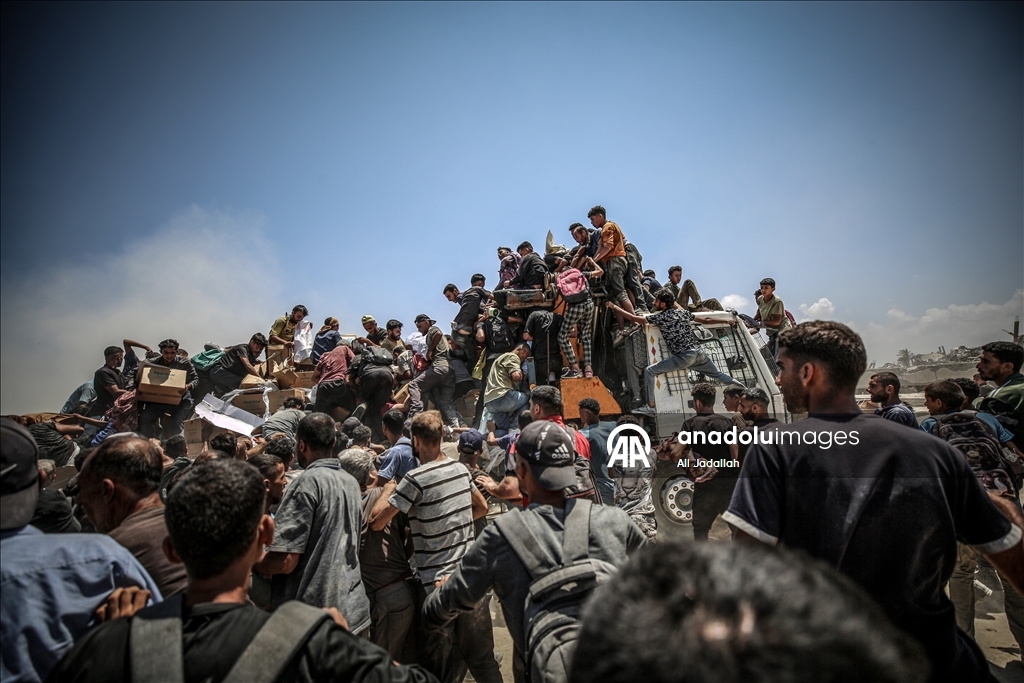 Palestinians receive limited amount of flour and infant formula at distribution point in Gaza