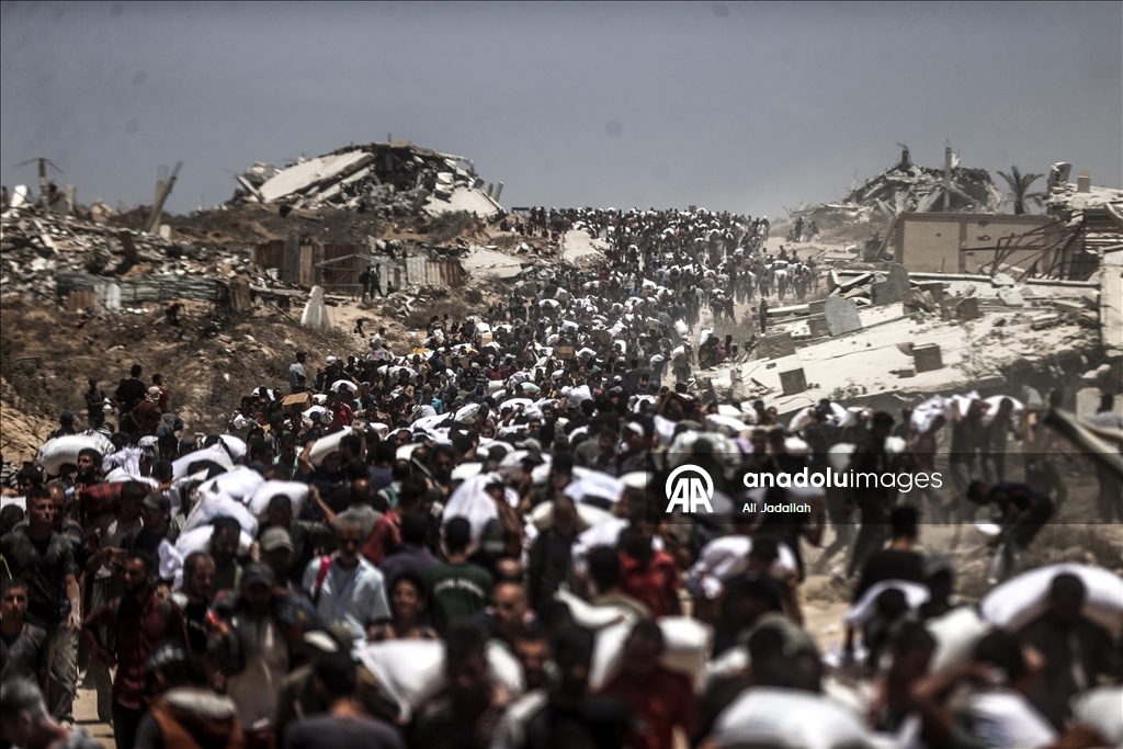Palestinians receive limited amount of flour and infant formula at distribution point in Gaza