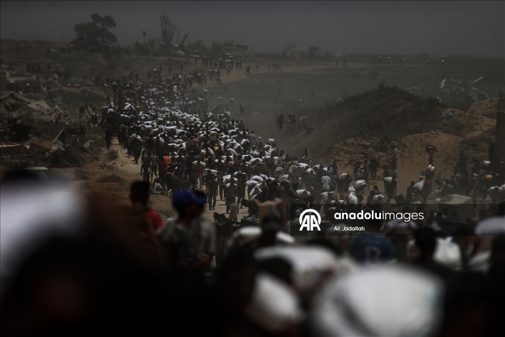Palestinians receive limited amount of flour and infant formula at distribution point in Gaza