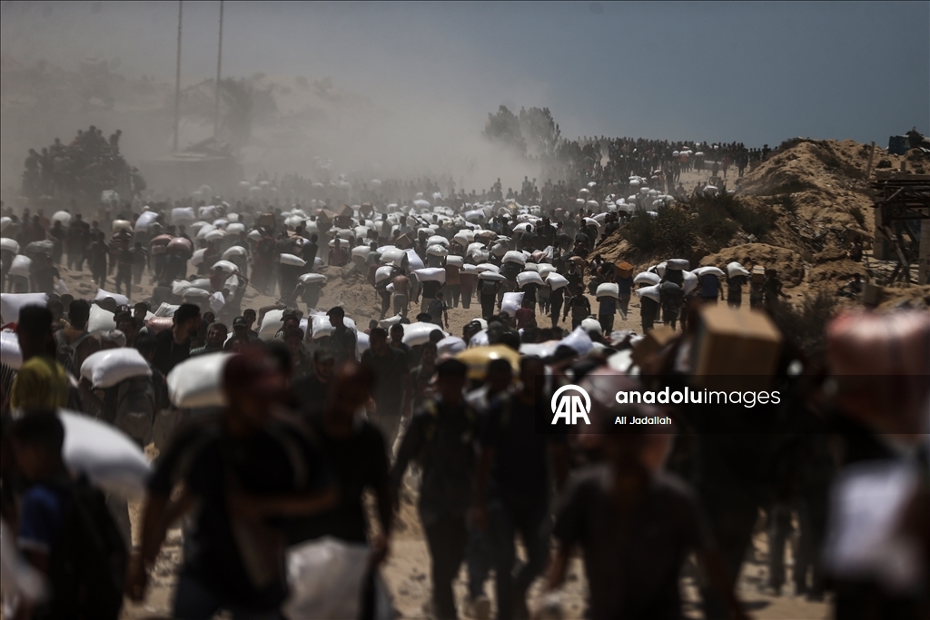Palestinians receive limited amount of flour and infant formula at distribution point in Gaza