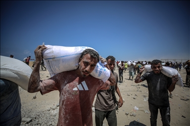 Palestinians receive limited amount of flour and infant formula at distribution point in Gaza