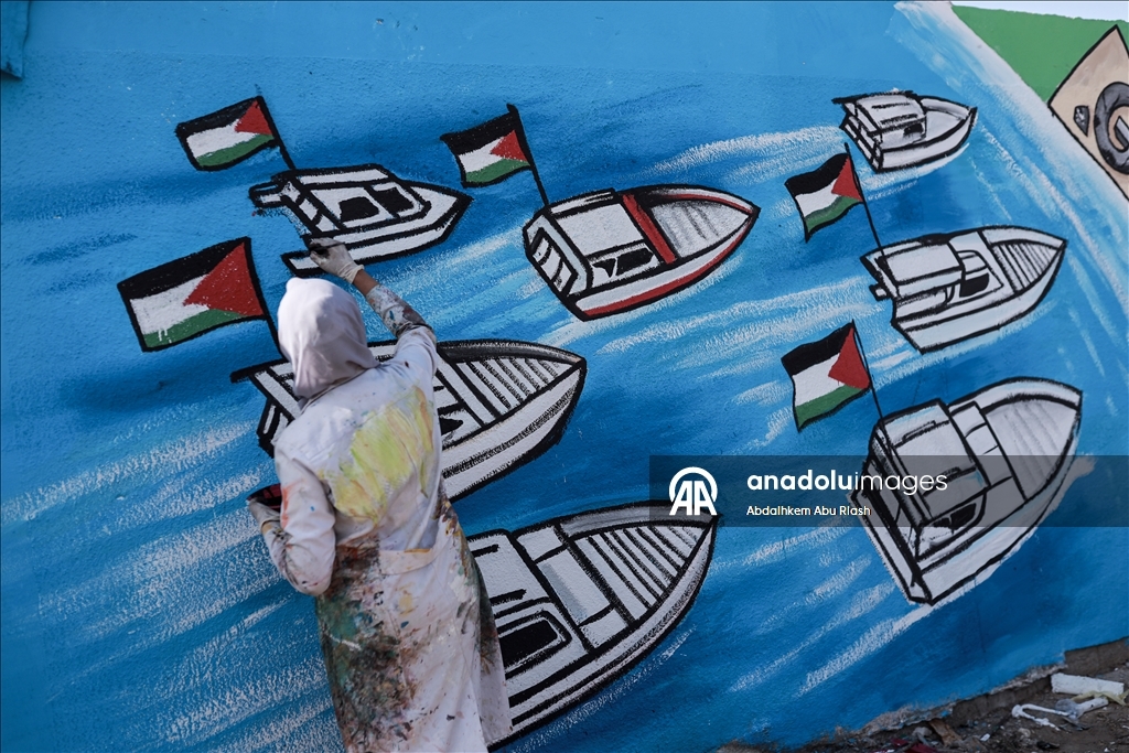 Palestinian artists create graffiti in support of Global Sumud Flotilla in Deir al-Balah