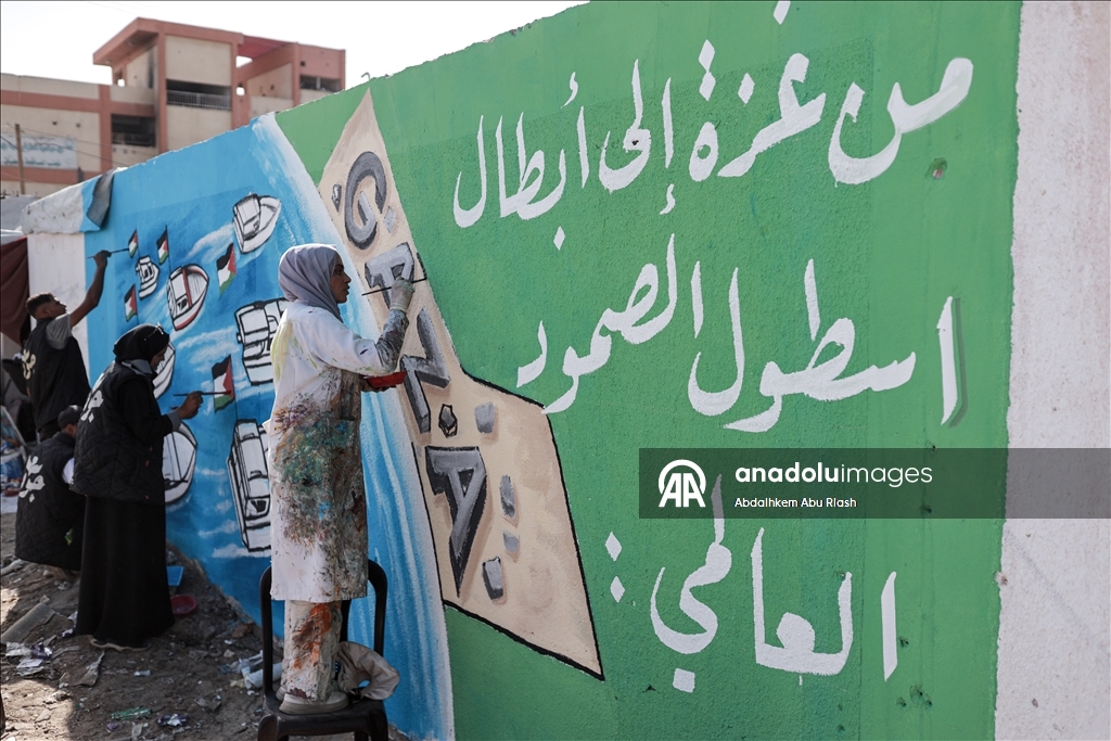 Palestinian artists create graffiti in support of Global Sumud Flotilla in Deir al-Balah