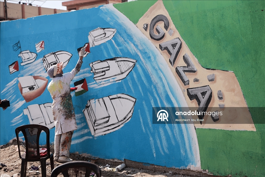 Palestinian artists create graffiti in support of Global Sumud Flotilla in Deir al-Balah