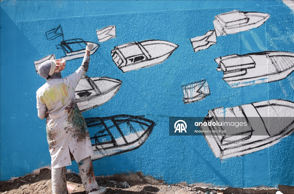 Palestinian artists create graffiti in support of Global Sumud Flotilla in Deir al-Balah