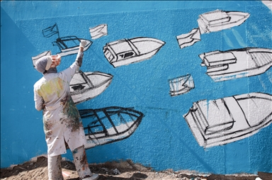 Palestinian artists create graffiti in support of Global Sumud Flotilla in Deir al-Balah