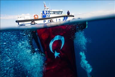 Turkish divers unfurl flag on sunken ship to mark the 102nd Republic Day 