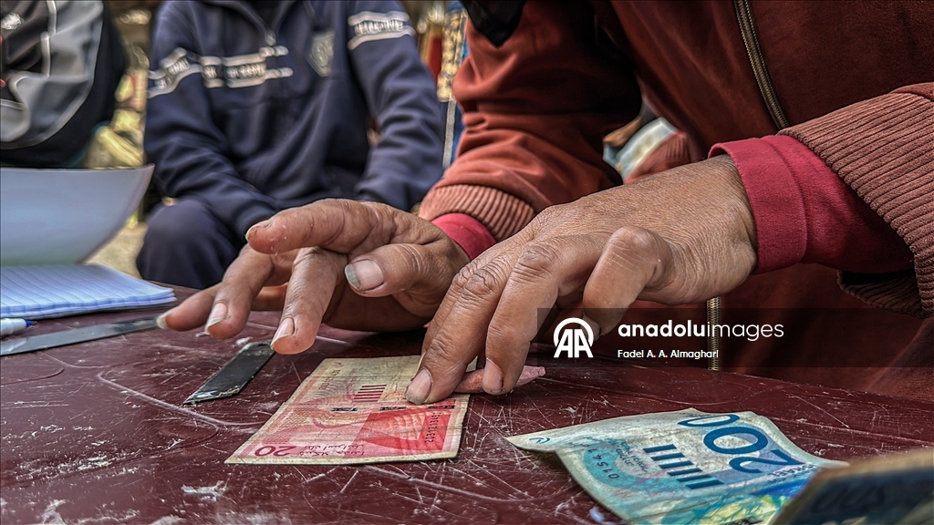 Filistinli kadın, eski ve yırtılmış banknotları onararak ailesinin geçimini sağlıyor