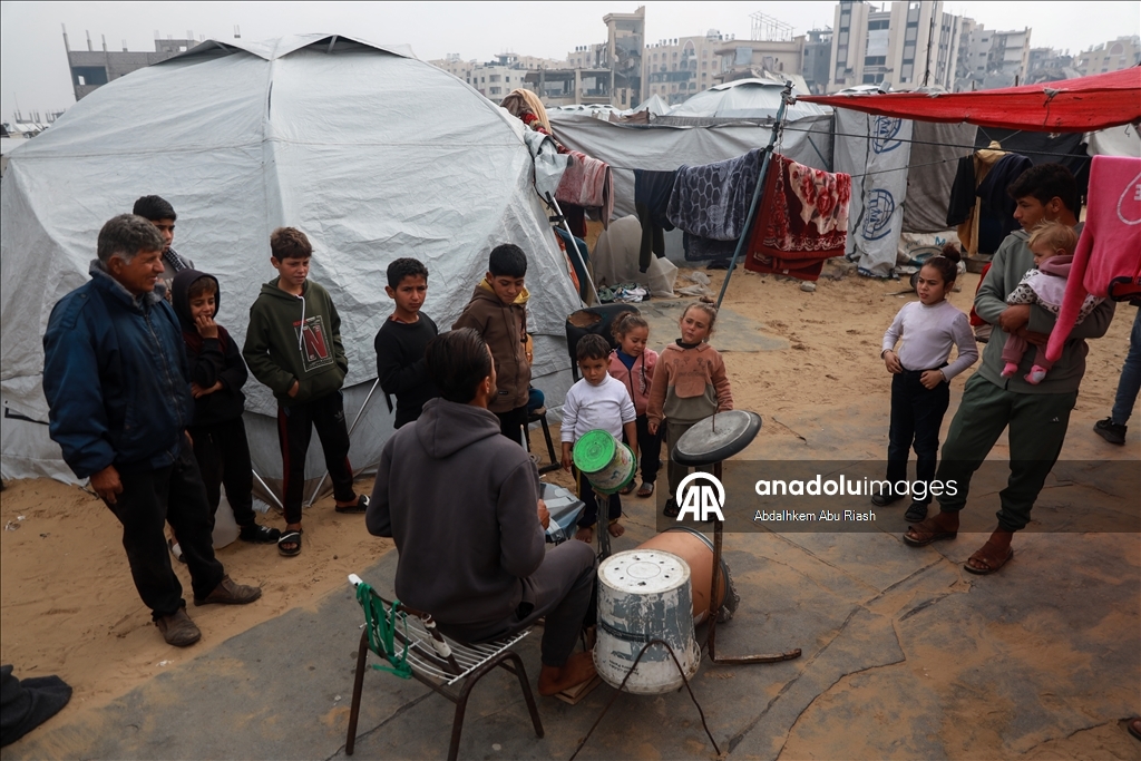 Filistinli genç basit imkanlarla yaptığı davulla sığınmacılara moral vermeye çalışıyor