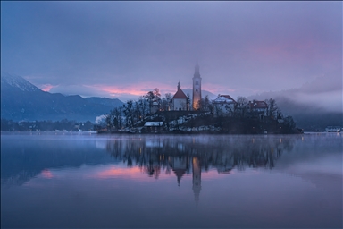 Slovenia's Lake Bled offers stunning views as fog blankets historic island